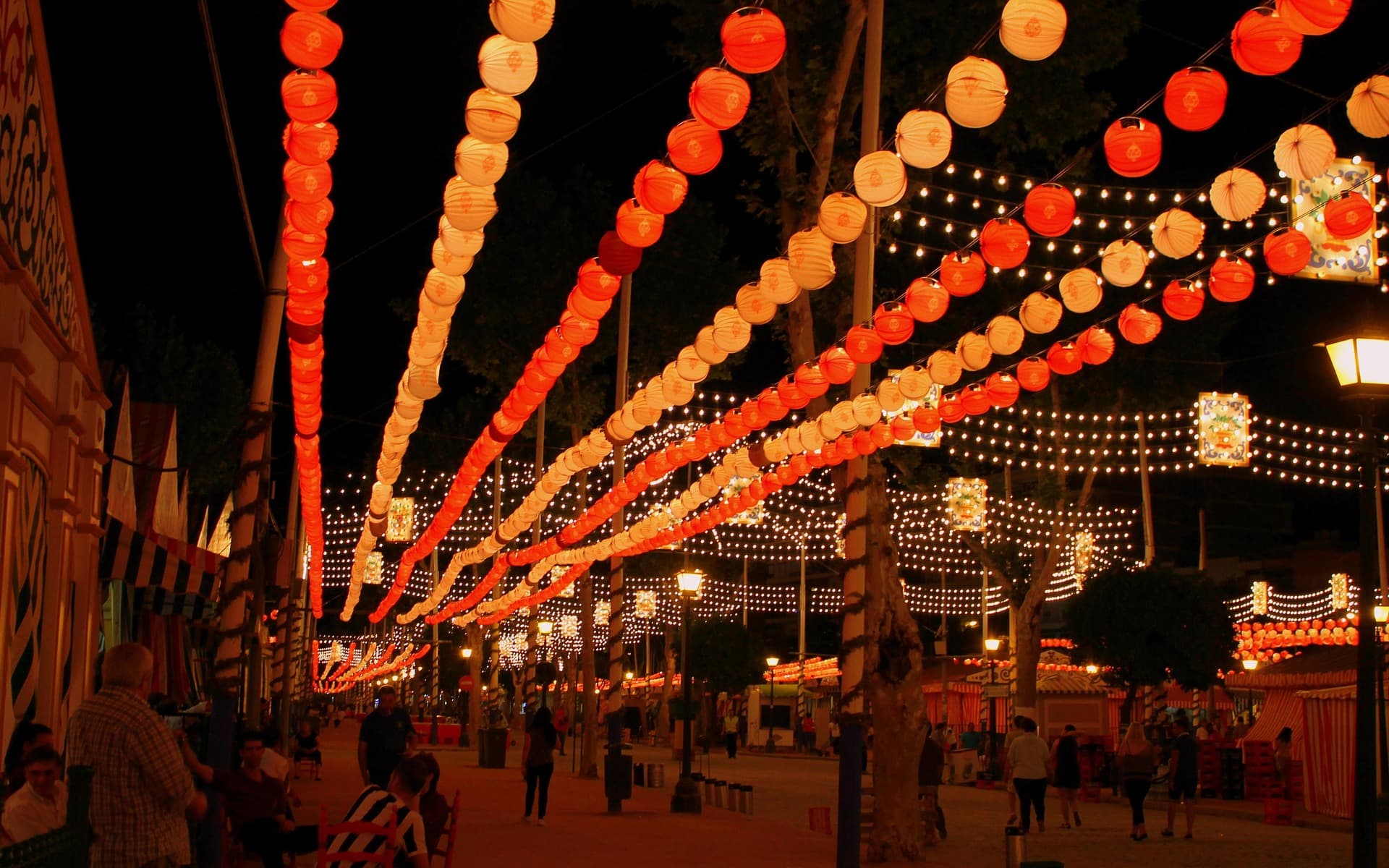 Luminous garlands over a Seville street during festival season